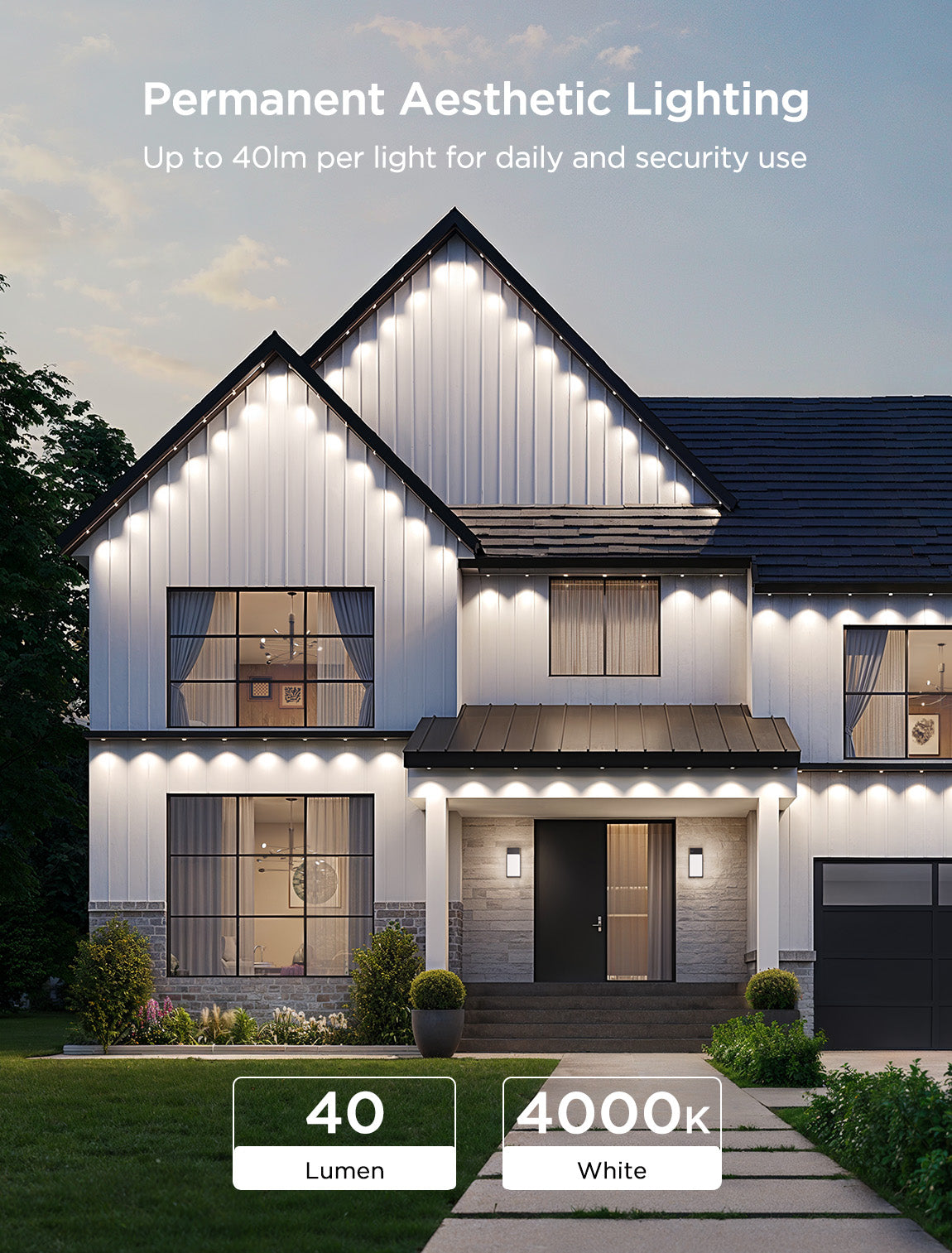 A modern two-story house with white siding and a dark roof is lit by permanent outdoor Christmas lights.